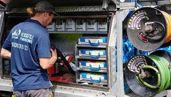 Plumber working from the ute drawers